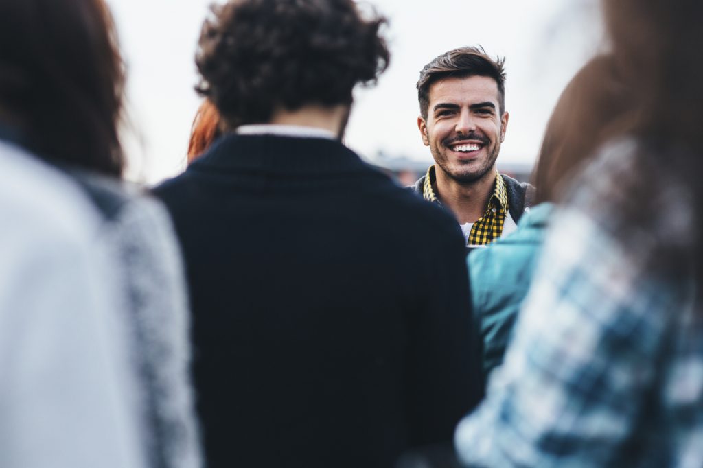 Man staring out from a crowd