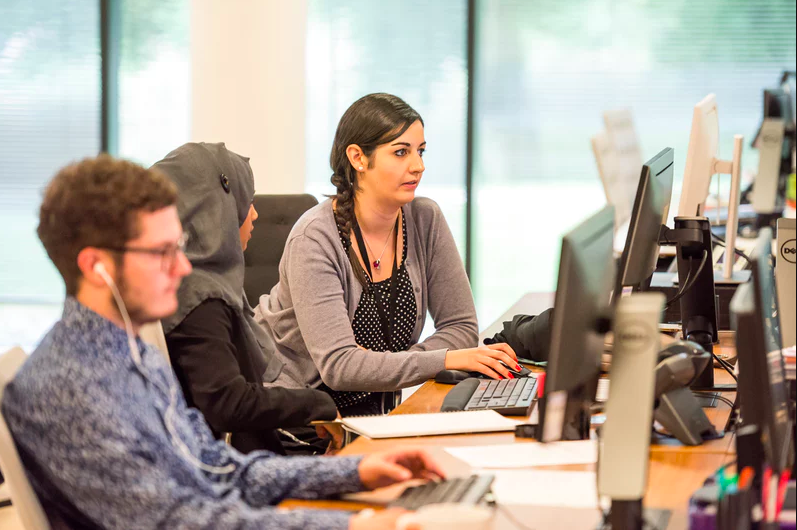 Young professionals working at their computers in a modern office.