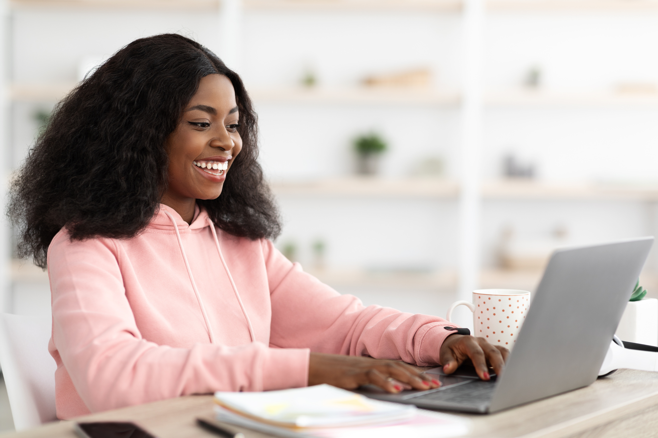 Happy employee smiling while working on her computer.