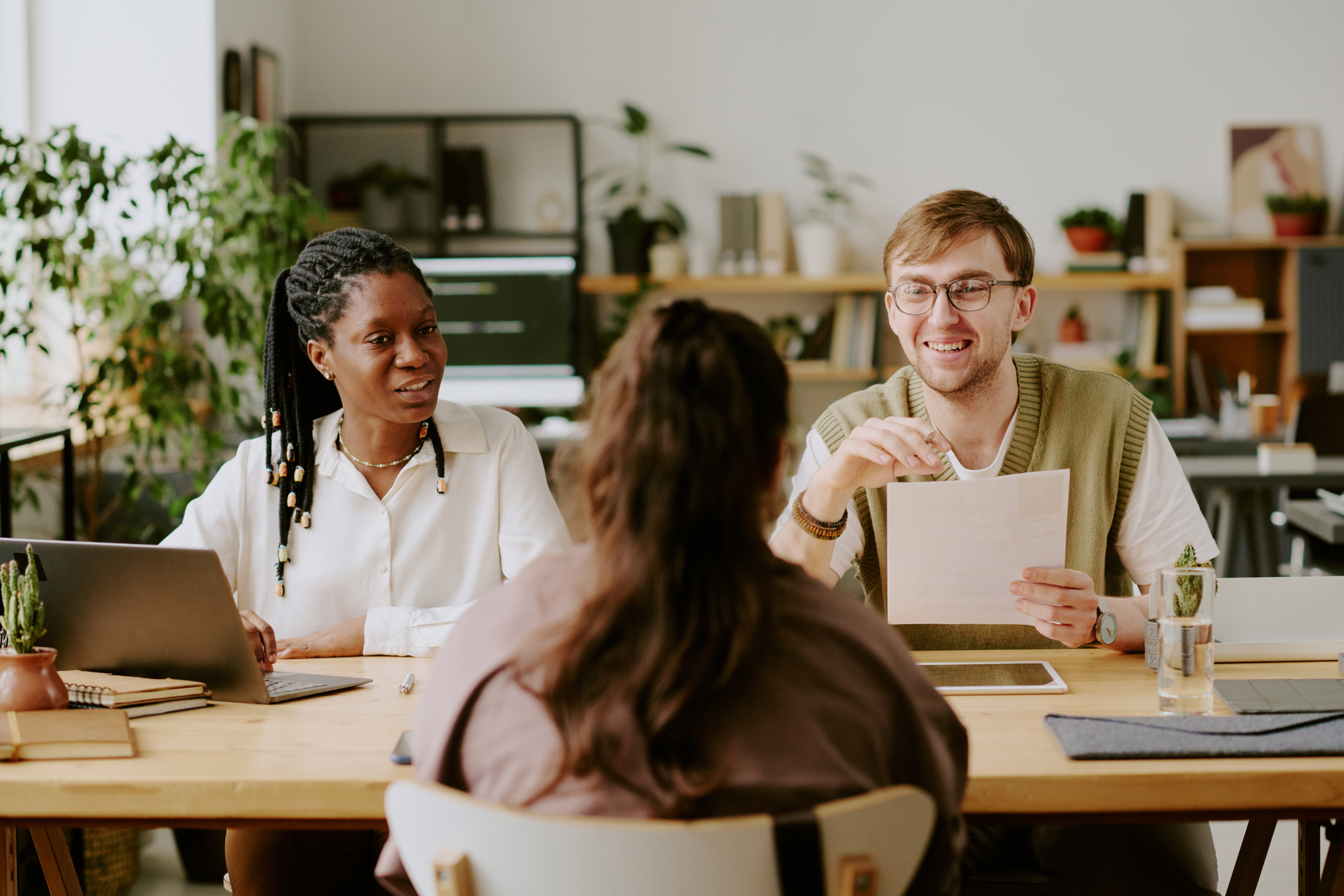 Recruiters interviewing a job candidate during an in-person hiring meeting.